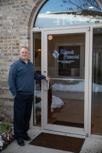 Dale standing at the door of Schrock Financial